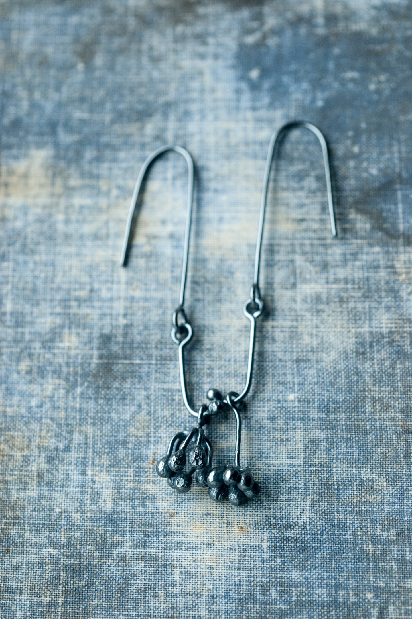 Raw oxidised silver dangle earrings with botanical forms, handmade by Undergrowth Studio.